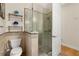Bathroom with a glass-enclosed shower, tile accents, and modern fixtures, offering a luxurious experience at 3349 Schoolhouse Rd, Harmony, FL 34773