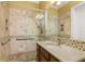 Bathroom featuring a walk-in shower, granite vanity, and modern fixtures, offering a luxurious experience at 3349 Schoolhouse Rd, Harmony, FL 34773