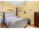 Bedroom featuring a comfy bed, chest of drawers and lots of artwork at 3349 Schoolhouse Rd, Harmony, FL 34773