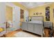 Bedroom with neutral walls, a gray bed frame, and hardwood floors, creating a serene retreat at 3349 Schoolhouse Rd, Harmony, FL 34773