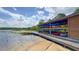 Lakeside boat storage with stacked canoes and a wooden dock, perfect for water activities and enjoying the scenic views at 3349 Schoolhouse Rd, Harmony, FL 34773