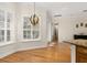 Dining area with hardwood floors, white shutters and modern chandelier at 3349 Schoolhouse Rd, Harmony, FL 34773