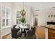 Bright dining area featuring a modern chandelier, hardwood floors, a marble table and seating for four at 3349 Schoolhouse Rd, Harmony, FL 34773