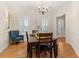 Spacious dining room featuring hardwood floors and large windows, creating a bright and inviting space at 3349 Schoolhouse Rd, Harmony, FL 34773