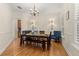 Elegant dining room with hardwood floors, chandelier, and wainscoting, perfect for formal gatherings at 3349 Schoolhouse Rd, Harmony, FL 34773