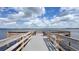 Tranquil wooden dock with chairs overlooking a serene lake, perfect for relaxation and enjoying waterfront views at 3349 Schoolhouse Rd, Harmony, FL 34773