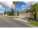 Charming home showcasing a well-maintained yard, a classic white fence, and a convenient two-car garage at 3349 Schoolhouse Rd, Harmony, FL 34773
