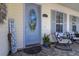 Charming front porch with seating and a decorative stained-glass front door at 3349 Schoolhouse Rd, Harmony, FL 34773