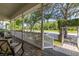 Charming front porch featuring brick flooring and classic white railings, offering serene outdoor space at 3349 Schoolhouse Rd, Harmony, FL 34773