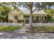 Charming yellow home with a white picket fence and lush landscaping at 3349 Schoolhouse Rd, Harmony, FL 34773