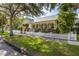 Charming yellow home with a white picket fence and lush landscaping at 3349 Schoolhouse Rd, Harmony, FL 34773