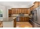 Modern kitchen with stainless steel appliances, granite countertops, and hardwood floors, designed for culinary excellence at 3349 Schoolhouse Rd, Harmony, FL 34773