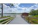 A walkway leads to a lake building with a dock offering scenic waterfront access in the community at 3349 Schoolhouse Rd, Harmony, FL 34773
