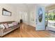 Bright living room with hardwood floors and decorative front door, creating a welcoming atmosphere at 3349 Schoolhouse Rd, Harmony, FL 34773