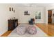 Living room showcasing hardwood floors, accent chair, and dark fireplace at 3349 Schoolhouse Rd, Harmony, FL 34773