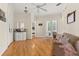 Open living room with hardwood floors, neutral tones, and French doors to backyard, providing a seamless indoor/outdoor living at 3349 Schoolhouse Rd, Harmony, FL 34773