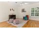 Living room featuring hardwood floors, ceiling fan, an accent chair, and dark fireplace at 3349 Schoolhouse Rd, Harmony, FL 34773