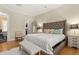 Serene main bedroom featuring hardwood floors, a plush bed, walk-in closet and en-suite bath at 3349 Schoolhouse Rd, Harmony, FL 34773