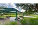 Shaded picnic area with multiple picnic tables, perfect for outdoor dining and gatherings in a park-like setting at 3349 Schoolhouse Rd, Harmony, FL 34773