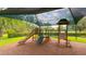 Well-maintained shaded playground with a slide, stairs, and play features for children to enjoy, set in a grassy area at 3349 Schoolhouse Rd, Harmony, FL 34773