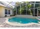 Sparkling screened-in pool with a serene water feature and a spacious patio for enjoying the outdoors at 3349 Schoolhouse Rd, Harmony, FL 34773