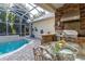 Relaxing screened-in pool area with outdoor kitchen, lush landscaping, and seamless indoor-outdoor living at 3349 Schoolhouse Rd, Harmony, FL 34773