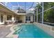 Inviting enclosed pool area with brick pavers and lush tropical landscaping, perfect for relaxation and outdoor enjoyment at 3349 Schoolhouse Rd, Harmony, FL 34773
