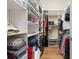 Organized walk-in closet with built-in shelving and plenty of storage space for clothes and accessories at 3349 Schoolhouse Rd, Harmony, FL 34773