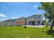 The backyard with lush green grass, patio, and white fence offers outdoor enjoyment at 3400 Mt Vernon Way, Kissimmee, FL 34741