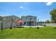 A large backyard features a well-maintained lawn, patio area, and privacy fence at 3400 Mt Vernon Way, Kissimmee, FL 34741