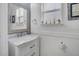 Charming bathroom features a vanity with white marble countertop, framed mirror and window at 3400 Mt Vernon Way, Kissimmee, FL 34741