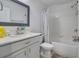 Bright bathroom featuring a shower-tub combination with a white vanity and framed mirror at 3400 Mt Vernon Way, Kissimmee, FL 34741