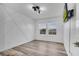 A bedroom featuring wood-look floors and two windows that provide natural light, alongside a modern wall design at 3400 Mt Vernon Way, Kissimmee, FL 34741