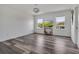 Bedroom with wood floors, two windows, and a media console table below the tv at 3400 Mt Vernon Way, Kissimmee, FL 34741