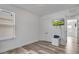 Cozy bedroom with wood-look floors, a window, closet and mounted TV, perfect for relaxation and entertainment at 3400 Mt Vernon Way, Kissimmee, FL 34741