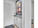 Hallway with door and built-in cabinets, topped with granite. Accented with modern artwork at 3400 Mt Vernon Way, Kissimmee, FL 34741