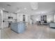 Spacious kitchen island and open living area with stainless steel appliances and modern light fixtures at 3400 Mt Vernon Way, Kissimmee, FL 34741