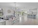 Open-concept living space with modern furnishings, tile floors, and seamless flow to the kitchen at 3400 Mt Vernon Way, Kissimmee, FL 34741