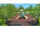 Neighborhood playground with mature trees, various play structures, and safety fence at 3400 Mt Vernon Way, Kissimmee, FL 34741