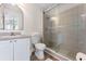 Bathroom features a shower with glass door, vanity, and toilet at 344 High Point Dr, Davenport, FL 33837