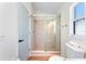 Bathroom featuring a glass-enclosed shower, vanity, and toilet at 344 High Point Dr, Davenport, FL 33837