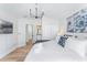 Bright bedroom features a closet, wood flooring, and a king bed with ensuite bathroom at 344 High Point Dr, Davenport, FL 33837
