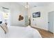 Bright bedroom features a TV, wood flooring, and a king bed with access to the kitchen at 344 High Point Dr, Davenport, FL 33837