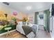 Bright bedroom featuring a mural and decorative pillows, creating a comfortable and inviting atmosphere at 344 High Point Dr, Davenport, FL 33837