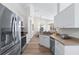 Bright kitchen with stainless steel appliances, light-colored cabinetry and countertops, and wood-look flooring at 344 High Point Dr, Davenport, FL 33837