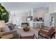 Open concept living space with modern furniture, tv, kitchen bar, and view of the front door at 344 High Point Dr, Davenport, FL 33837