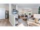 Open concept living room featuring modern decor, light colored flooring, and lots of natural light at 344 High Point Dr, Davenport, FL 33837