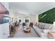 Bright living room with modern decor, plush seating, and views of the outdoor pool area at 344 High Point Dr, Davenport, FL 33837