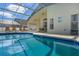 Exterior shot of a swimming pool with an outdoor lounging area, perfect for warm weather relaxation at 344 High Point Dr, Davenport, FL 33837
