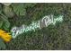 A bright and fun wall display of a neon sign that reads 'Enchanted Palms' at 344 High Point Dr, Davenport, FL 33837